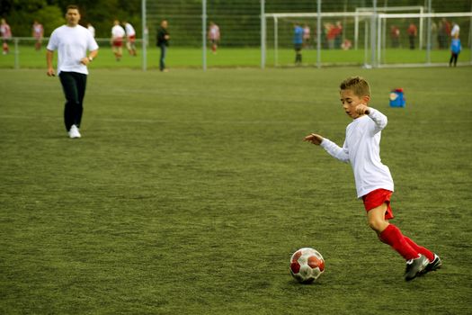 a young boy is playing soccer