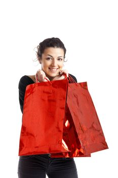 Beautiful young woman with shopping bags over white background