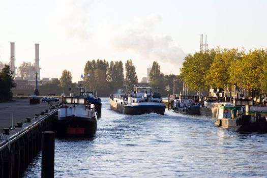 Ship leaving small port at sunrise in autumn