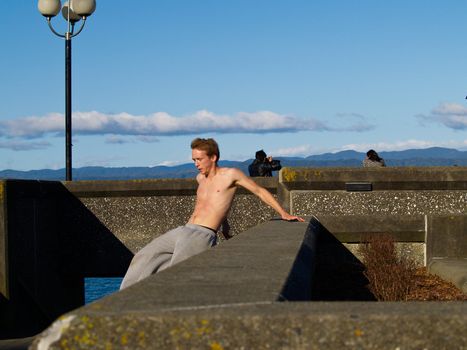 Parkour, male practicing on Wellington Waterfront. Also known as free running, and building jumping.