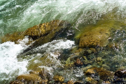 green water and stones in the stream 
