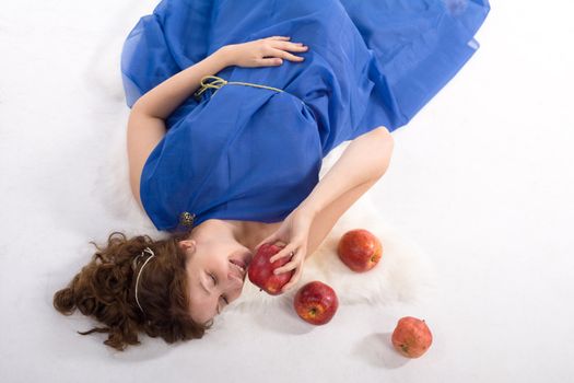 Lady in blue antique dress and red apples on white background
