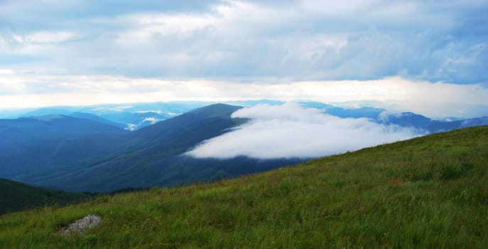 A big cloud flies in the Carpathian mountains