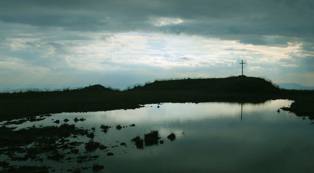 Cross above the lake marked the high peak of the mountains