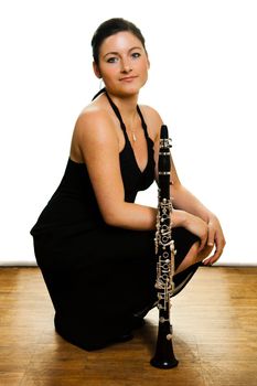 Beautiful clarinetist women posing on white background