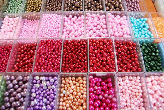 multicoloured beads sorted in boxes for sale