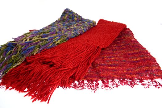 Three colorful wool scarfs isolated over white background.