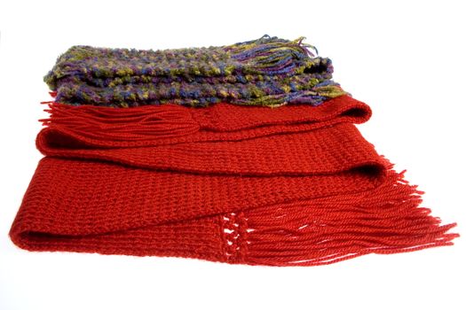Colorful wool scarfs isolated over white background.