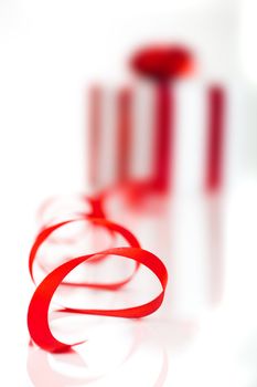 Gift wrapped with a red ribbon on a white background, Focus is on the ribbon