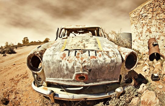 great image of an old car rusting away in the desert