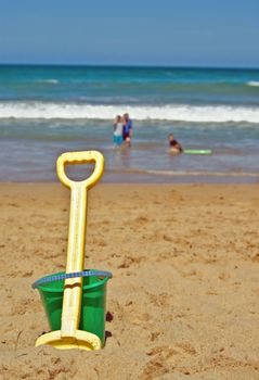 bucket and spade in the sand at the beach