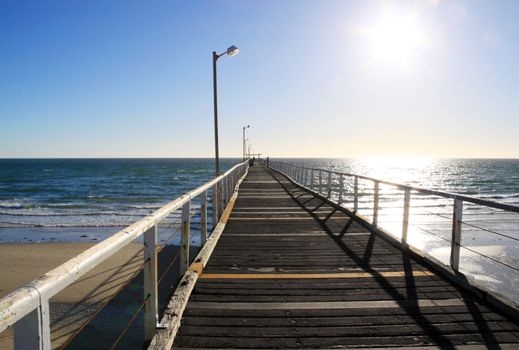 Long Wooden Jetty in Strong Sunlight. Largs Bay Jetty, Adelaide, Australia