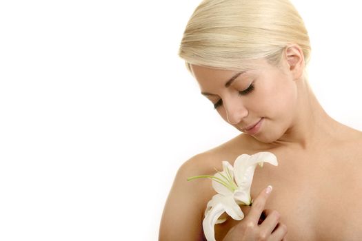 The beautiful girl, the blonde with a white lily on a white background
