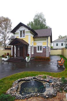 Kind on a cottage. A court yard with a lawn and pool
