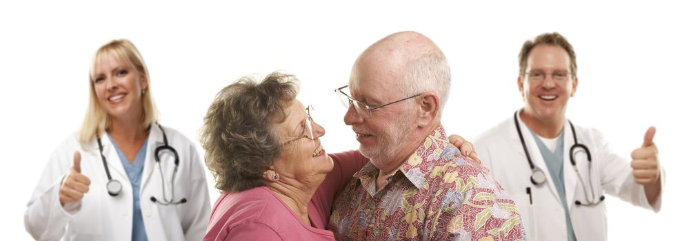 Senior Couple with Medical Doctors or Nurses with Thumbs Up Behind.