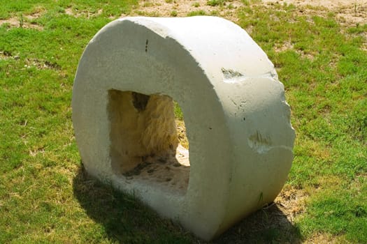 An ancient millstone were located on the grass in the natural background