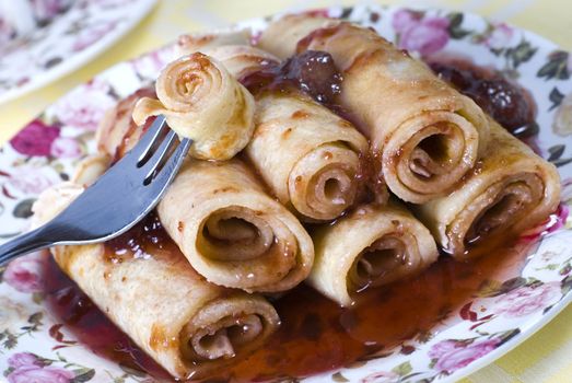 Pancakes with strawberries jam and fork