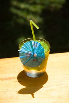 Glass of a freshening cold mint cocktail in hot day on a natural background