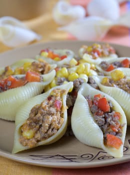 Baked conchiglioni rigati stuffed with minced beef garnished 