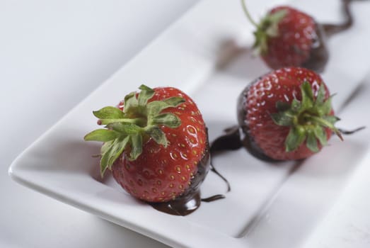   Strawberries with their tips dipped in hot chocolate 