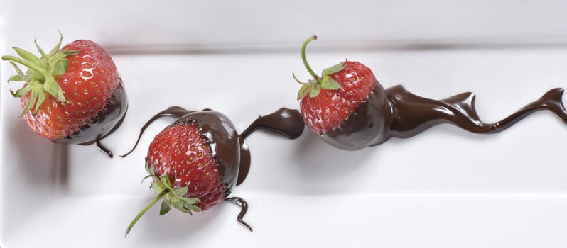  A strawberries on the dish with a decoration of chocolate