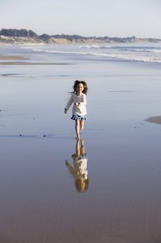 Little Girl Running in The Water at The Beach