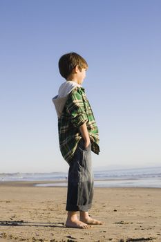 Portrait of a Little Boy Standing at The Beach