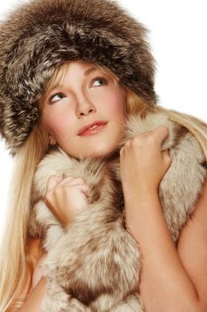 Beautiful young woman wrapped in fur on isolated background