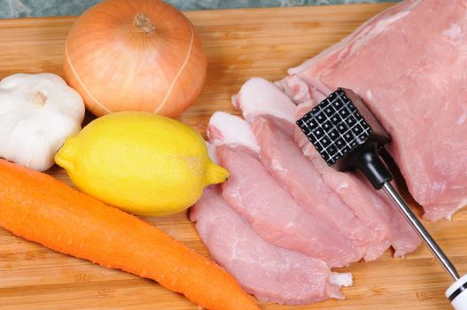 The cook prepares a chop from pork