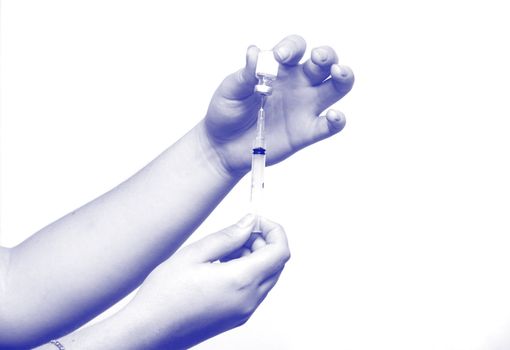 Hands of the nurse typing a medicine in a syringe on white background