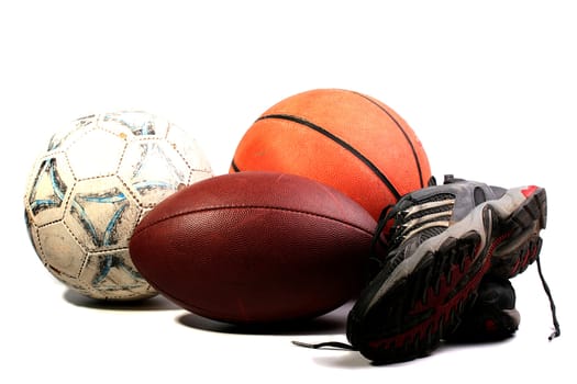Old balls for game in football, basketball and socker together with old sports footwear.