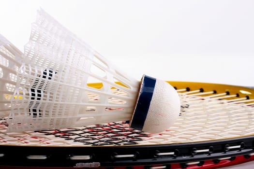 White shuttlecocks for badminton and a racket.