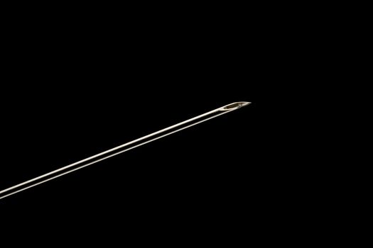 End of a syringe needle sharp close-up, clear outlines on black background