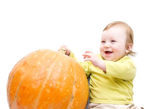 Happy baby boy playing with pumpkin over white