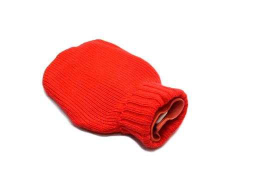 Red hot water bottle made of rubber and woven over white