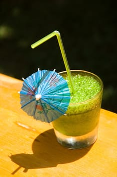 Glass of a freshening cold mint cocktail in hot day on a natural background