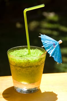 Glass of a freshening cold mint cocktail in hot day on a natural background