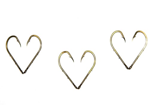 The anodized steel fishing hooks on a white background