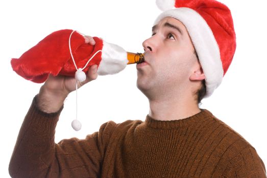 A young man drinking alcohol which is wrapped in a red sack, isolated against a white background