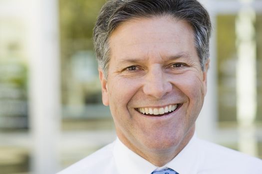 Portrait of a Smiling Businessman Standing Outdoors