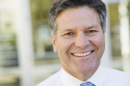 Portrait of a Smiling Businessman Standing Outdoors