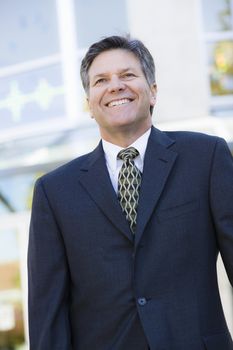 Portrait of a Smiling Businessman Standing Outdoors