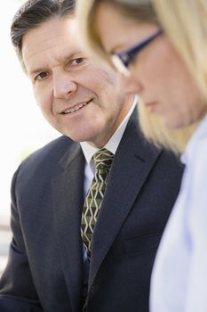 Portrait of a Smiling Businessman Looking at a Co-Worker