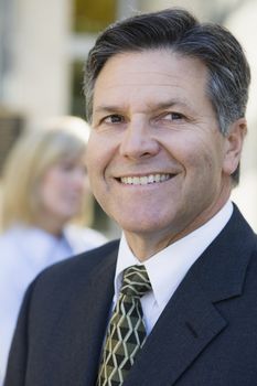 Portrait of a Smiling Businessman Looking Away From Camera