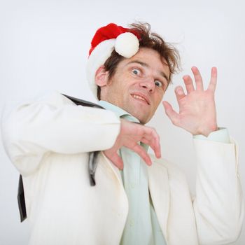 Portrait of the scared person in a New Year hat on a white background
