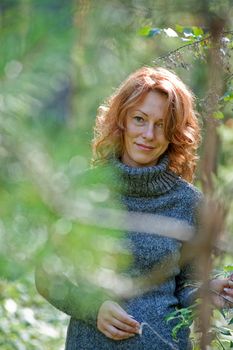 Portrait of red-haired adult women in nature
