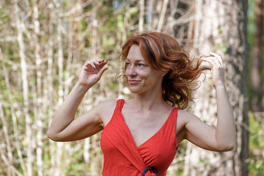 Portrait of red-haired adult women in nature