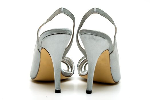 Elegant female shoes with a high heel on a white background