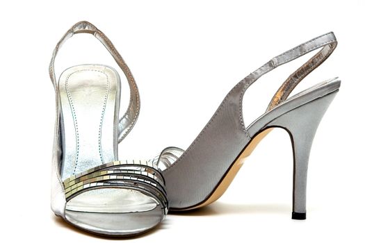 Elegant female shoes with a high heel on a white background