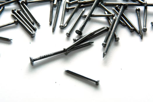 Stack of iron nails on white background